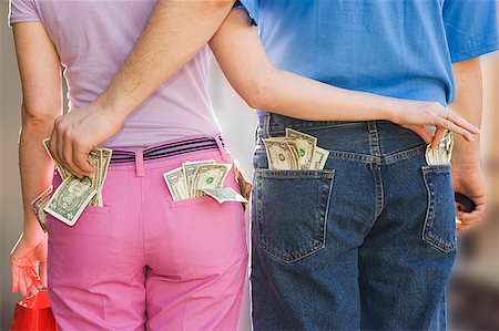 sneaky man - Couple sneaking money from each other Stock Photo - Premium Royalty-Free, Code: 673-02139302