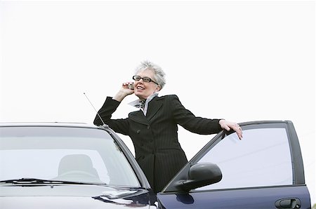 simsearch:673-02138722,k - Woman next to car using mobile phone Stock Photo - Premium Royalty-Free, Code: 673-02139375