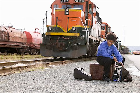 Boy with luggage and Boston Terrier Stock Photo - Premium Royalty-Free, Code: 673-02139423