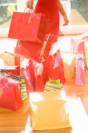 enigma - Woman surrounded by shopping bags Stock Photo - Premium Royalty-Free, Code: 673-02139475