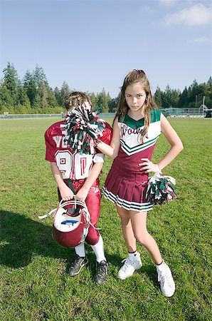 Cheerleader posing with football player Stock Photo - Premium Royalty-Free, Code: 673-02139506