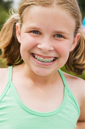 Smiling girl wearing orthodontic braces Stock Photo - Premium Royalty-Free, Code: 673-02139508