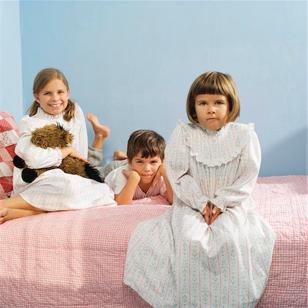 Children sitting on bed in pajamas Foto de stock - Sin royalties Premium, Código: 673-02139548