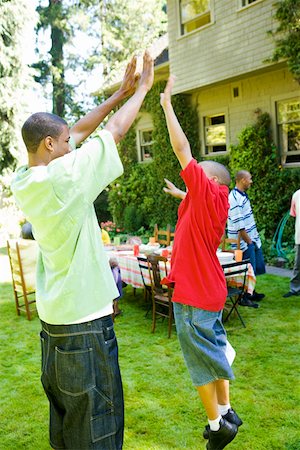 short - Boys giving each other a high five Stock Photo - Premium Royalty-Free, Code: 673-02139613