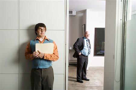 funny man with specs - Employee hiding from the boss Stock Photo - Premium Royalty-Free, Code: 673-02139681