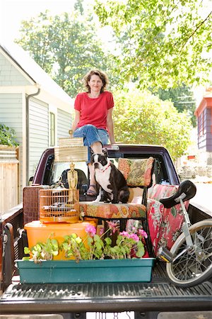 Woman with loaded pickup and dog Stock Photo - Premium Royalty-Free, Code: 673-02139931