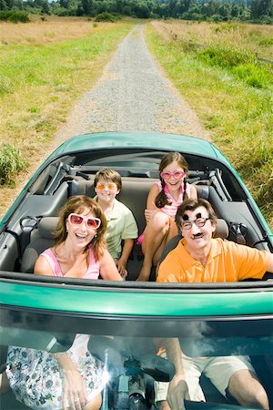 funny convertible car image - Playful family in convertible Stock Photo - Premium Royalty-Free, Code: 673-02139941