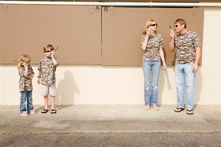 Family in camouflage playing with radios Stock Photo - Premium Royalty-Free, Code: 673-02139956