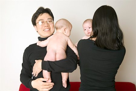 father with baby posing - Parents holding twin babies Stock Photo - Premium Royalty-Free, Code: 673-02139993