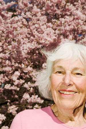 elderly woman beauty - Smiling woman with flowering tree Stock Photo - Premium Royalty-Free, Code: 673-02140032