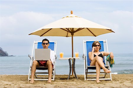 funny pictures of people talking on telephones - Couple using laptop and phone on beach Stock Photo - Premium Royalty-Free, Code: 673-02140097