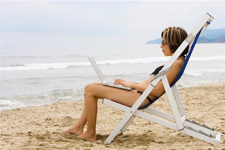 simsearch:400-04168729,k - Woman using laptop at beach Stock Photo - Premium Royalty-Free, Code: 673-02140101