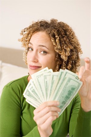 fanned out - Portrait of woman with handful of money Stock Photo - Premium Royalty-Free, Code: 673-02140323