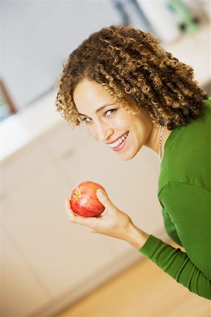 simsearch:673-02140337,k - Portrait of woman with apple in kitchen Stock Photo - Premium Royalty-Free, Code: 673-02140339