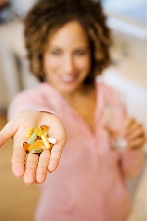 Pills in female outstretched palm Stock Photo - Premium Royalty-Free, Code: 673-02140347