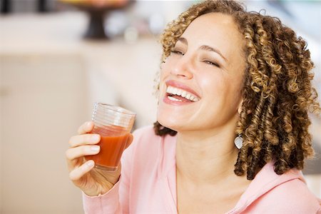 Laughing woman with tomato juice Stock Photo - Premium Royalty-Free, Code: 673-02140343
