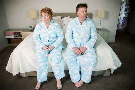 embarrassed man - Overweight couple in matching pajamas Stock Photo - Premium Royalty-Free, Code: 673-02140407