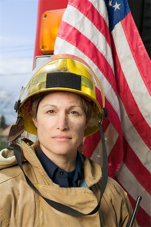 firefighter female - Female firefighter with American flag Foto de stock - Sin royalties Premium, Código: 673-02140452