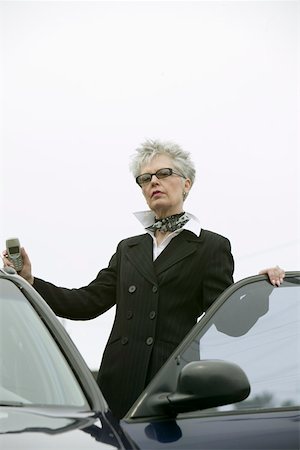 Fashionable middle aged woman with car Stock Photo - Premium Royalty-Free, Code: 673-02140475