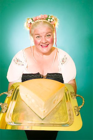 portrait of chubby blonde woman - Woman in Germanic costume with cheese wedge Stock Photo - Premium Royalty-Free, Code: 673-02140476
