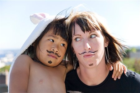 Playful woman and girl with painted mustaches Fotografie stock - Premium Royalty-Free, Codice: 673-02140535