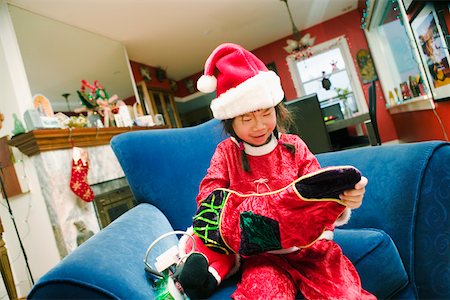 Girl in santa hat with Christmas stocking Stock Photo - Premium Royalty-Free, Code: 673-02140584