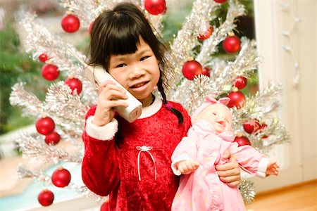 single christmas ball ornament - Girl with phone and doll on Christmas Stock Photo - Premium Royalty-Free, Code: 673-02140580