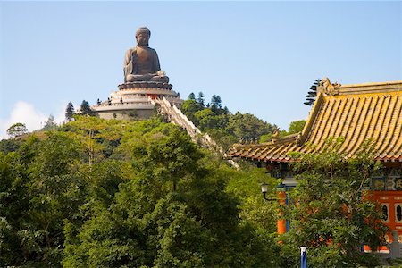 Giant Buddha atop tree covered hill in Hong Kong Stock Photo - Premium Royalty-Free, Code: 673-02140666