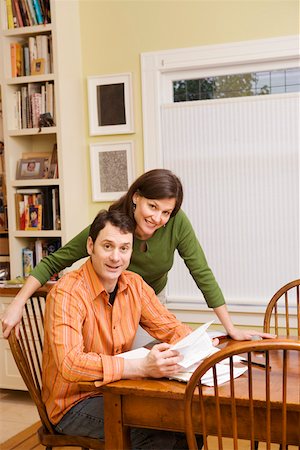 Portrait of couple doing paperwork at home Stock Photo - Premium Royalty-Free, Code: 673-02140797