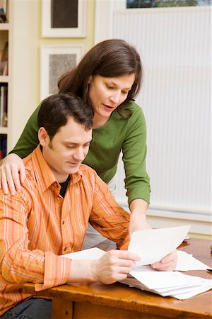 Portrait of couple doing paperwork at home Stock Photo - Premium Royalty-Free, Code: 673-02140798
