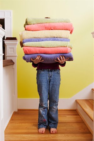 funny short height - Child carrying tall stack of towels on stairs Stock Photo - Premium Royalty-Free, Code: 673-02140810