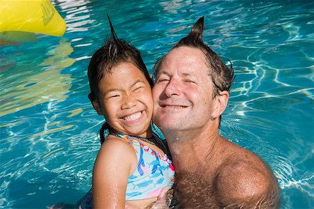 play swim girl photos - Father and daughter with silly hairdos in pool Stock Photo - Premium Royalty-Free, Code: 673-02140940