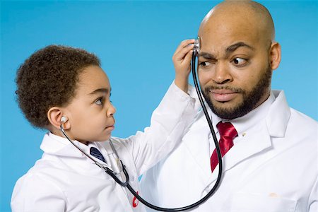 doctor teaching - Young boy with stethoscope and male doctor Stock Photo - Premium Royalty-Free, Code: 673-02140978