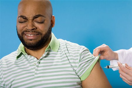 Man receiving injection in the arm Stock Photo - Premium Royalty-Free, Code: 673-02141034