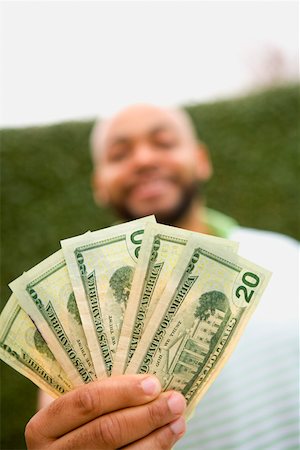 financiación - Man holding twenty dollar bills Foto de stock - Sin royalties Premium, Código: 673-02141038