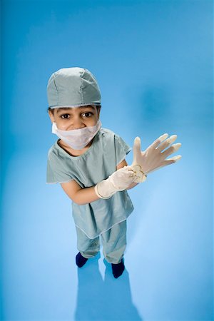 doctor with cap and mask - High angle portrait of young boy dressed in scrubs Stock Photo - Premium Royalty-Free, Code: 673-02141032