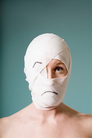 enclosed - Sad woman with head wrapped in bandage Stock Photo - Premium Royalty-Free, Code: 673-02141164