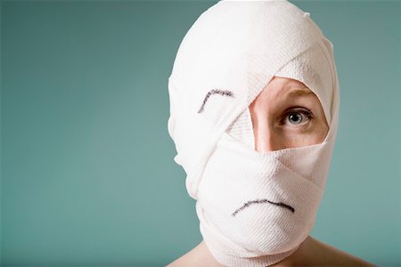 plastic surgery woman face - Portrait of woman with head wrapped in bandage Stock Photo - Premium Royalty-Free, Code: 673-02141165