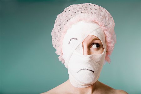 plaster face woman - Sad woman with head wrapped in bandage Stock Photo - Premium Royalty-Free, Code: 673-02141166