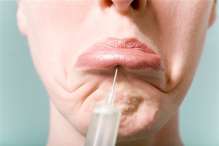 syringe woman face - Close up of woman receiving injection in lips Stock Photo - Premium Royalty-Free, Code: 673-02141169