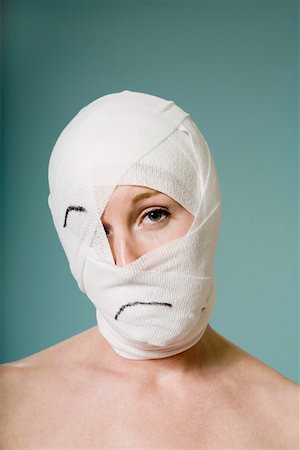 plaster face woman - Woman with head wrapped in bandage Stock Photo - Premium Royalty-Free, Code: 673-02141162