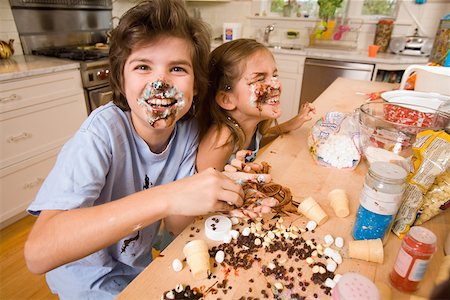 families and chocolate - Portrait of boy and girl making mess in kitchen Stock Photo - Premium Royalty-Free, Code: 673-02141217