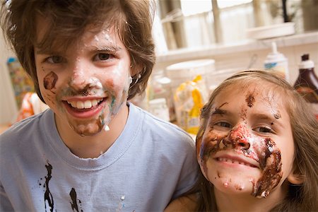 families and chocolate - Close up portrait of brother and sister with food on face Stock Photo - Premium Royalty-Free, Code: 673-02141225