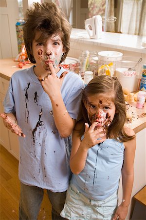 families and chocolate - Portrait of brother and sister with food on face Stock Photo - Premium Royalty-Free, Code: 673-02141222