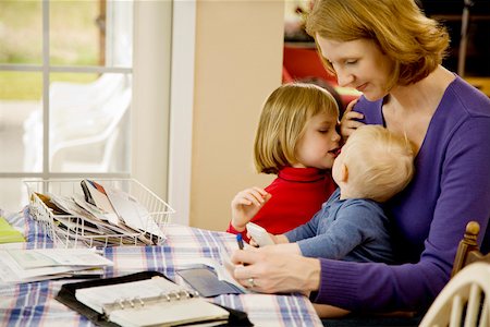 remunerating - Mother holding children while writing Stock Photo - Premium Royalty-Free, Code: 673-02141233