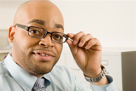 Portrait of businessmen adjusting glasses Stock Photo - Premium Royalty-Free, Code: 673-02141323