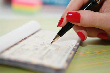 person writing in check book - Hand writing check Stock Photo - Premium Royalty-Free, Code: 673-02141344