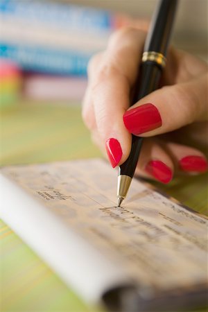 person writing in check book - Hand writing check Stock Photo - Premium Royalty-Free, Code: 673-02141345