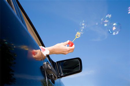simsearch:673-02143413,k - Woman blowing bubbles out car window Stock Photo - Premium Royalty-Free, Code: 673-02141453