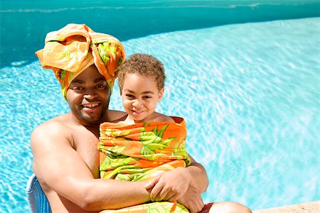 Father and son drying off by pool Stock Photo - Premium Royalty-Free, Code: 673-02141566